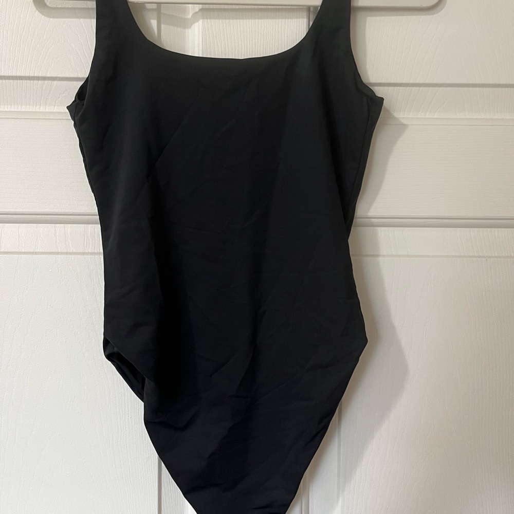 FashionNova one piece swimsuit or bodysuit. Runs small to size. Nylon/spandex